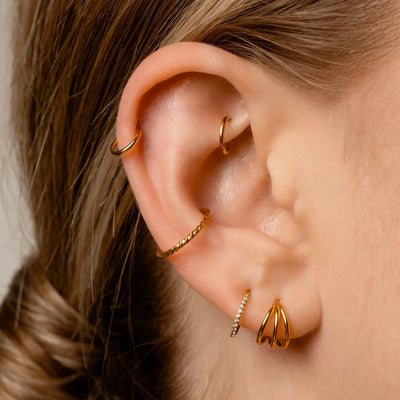 huggie earrings on an ear